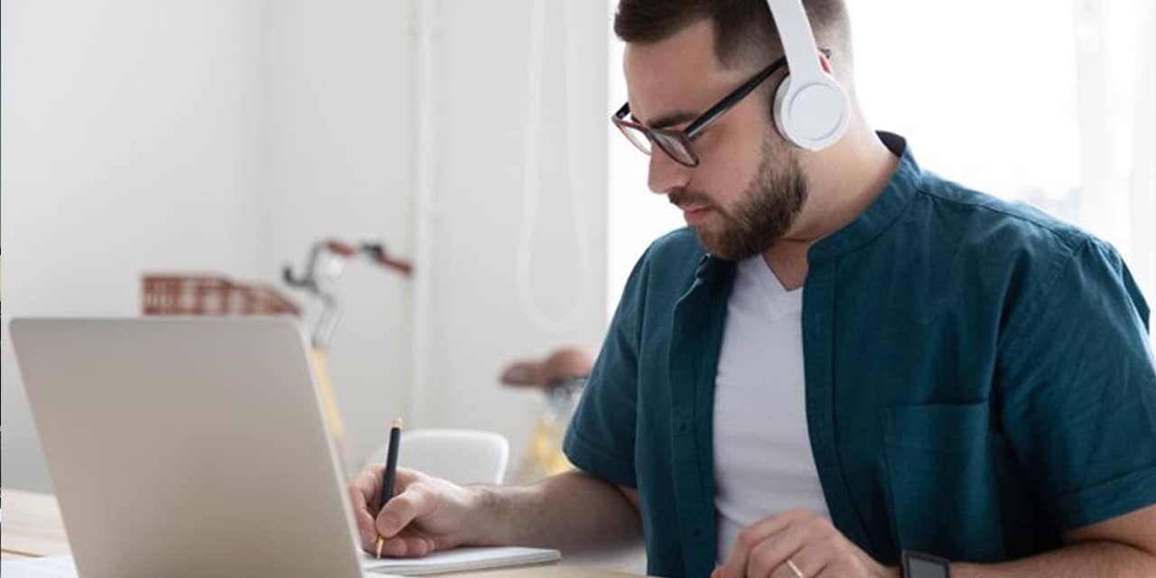 Man on laptop with headphones 