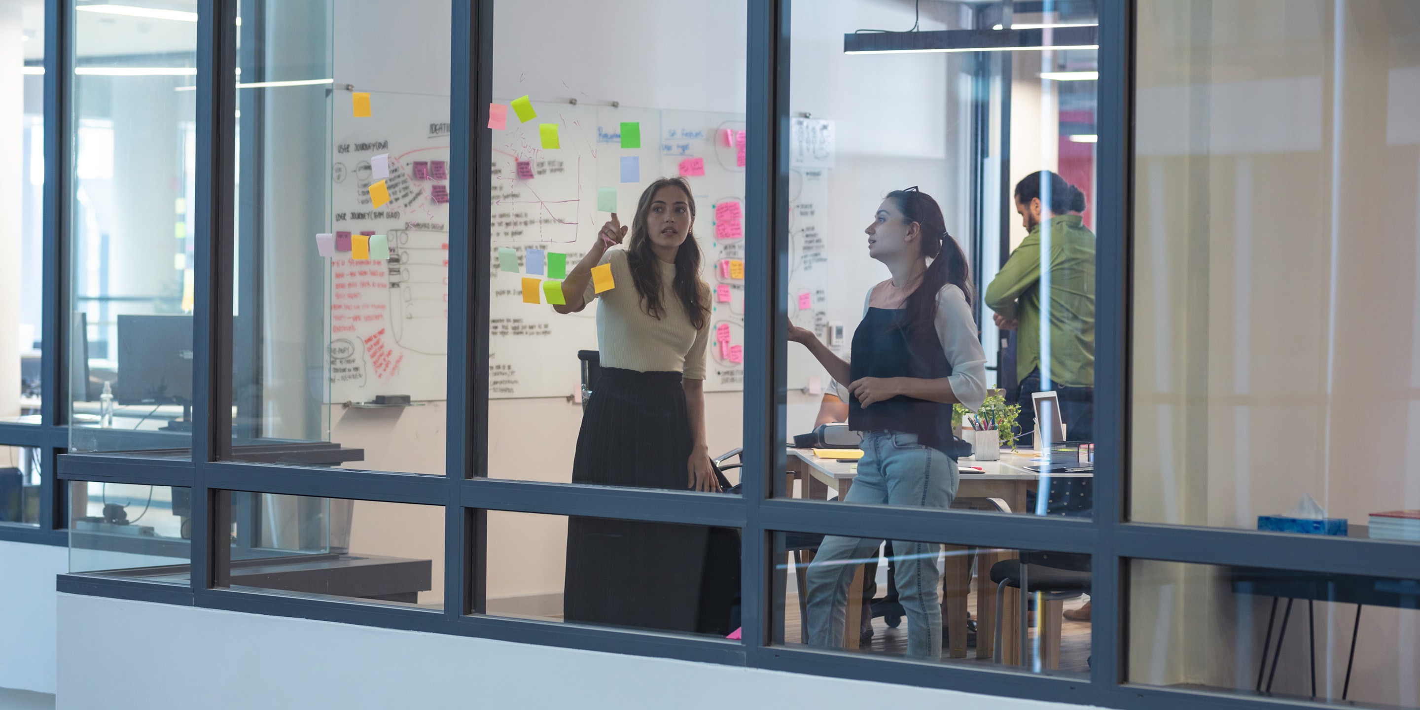 Employees brainstorming inside conference room.