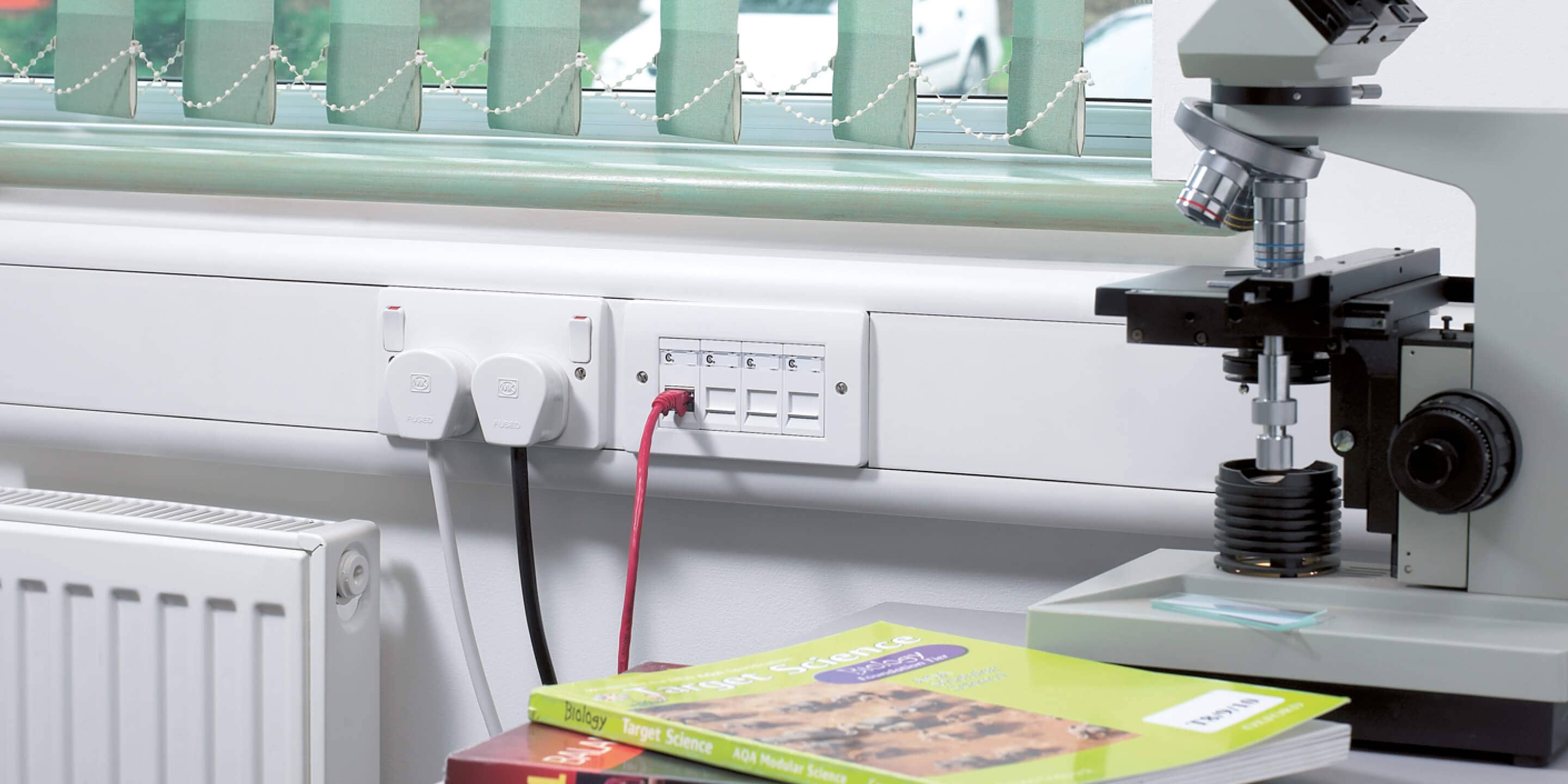 Prestige 3D compact product near microscope and science books 