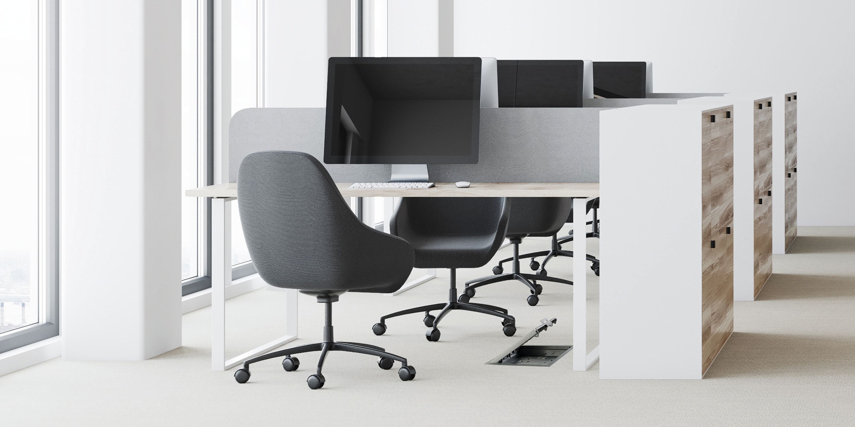 People working at desk in middle of office