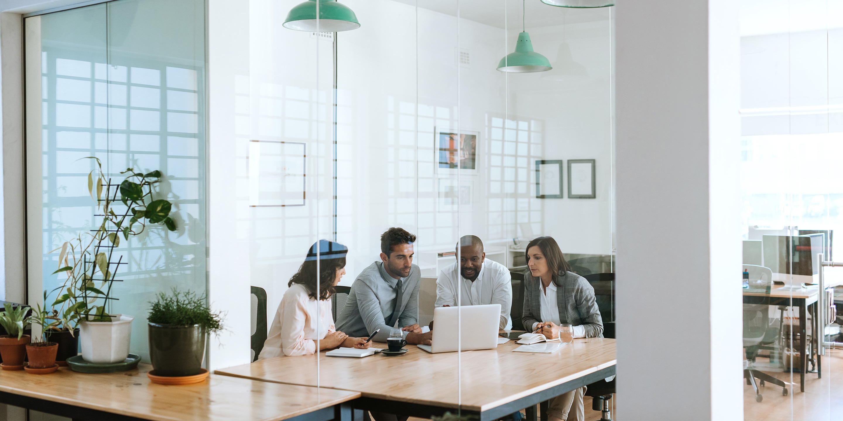 Employees inside office building conference room.
