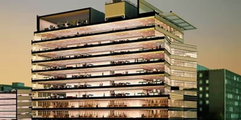 Discover a striking view of a multi-story office building with glass facades and illuminated interiors. Perfect for themes related to corporate life, architecture, or urban development.