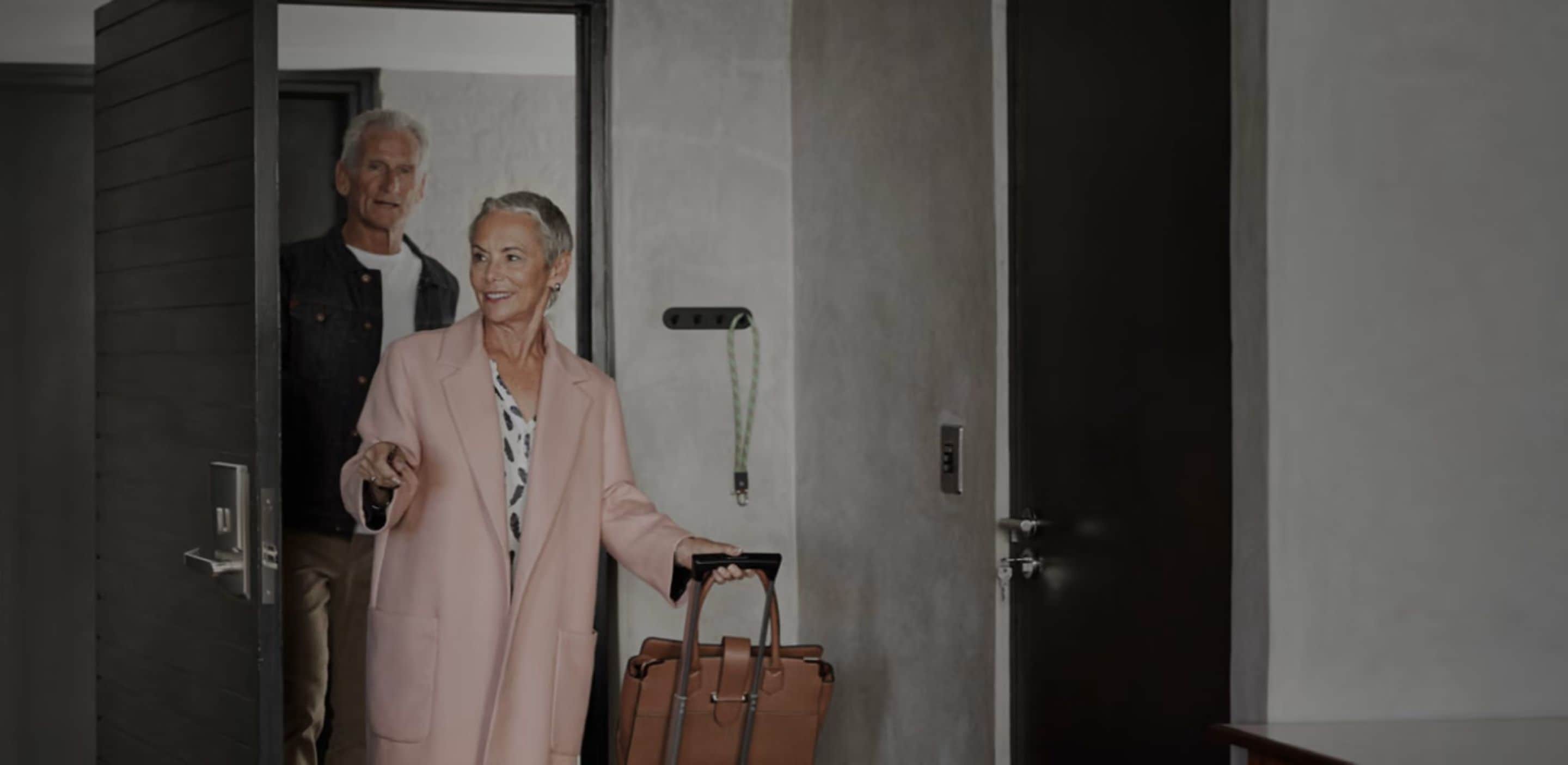 Man and woaman walking into hotel room