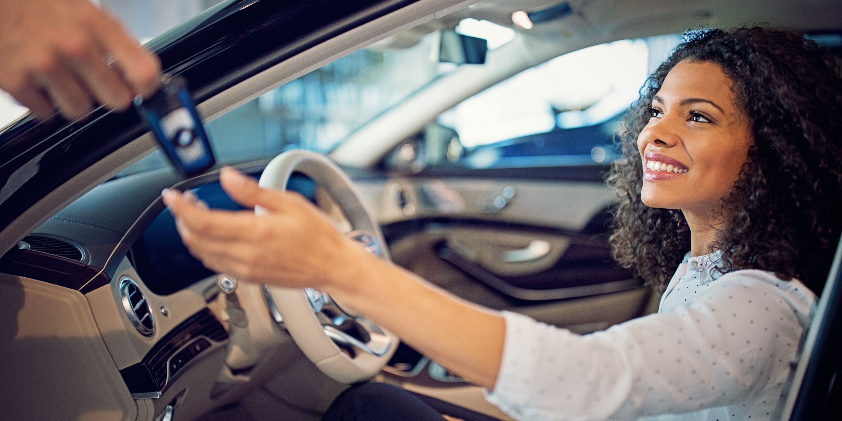 Woman recieving keys to her car