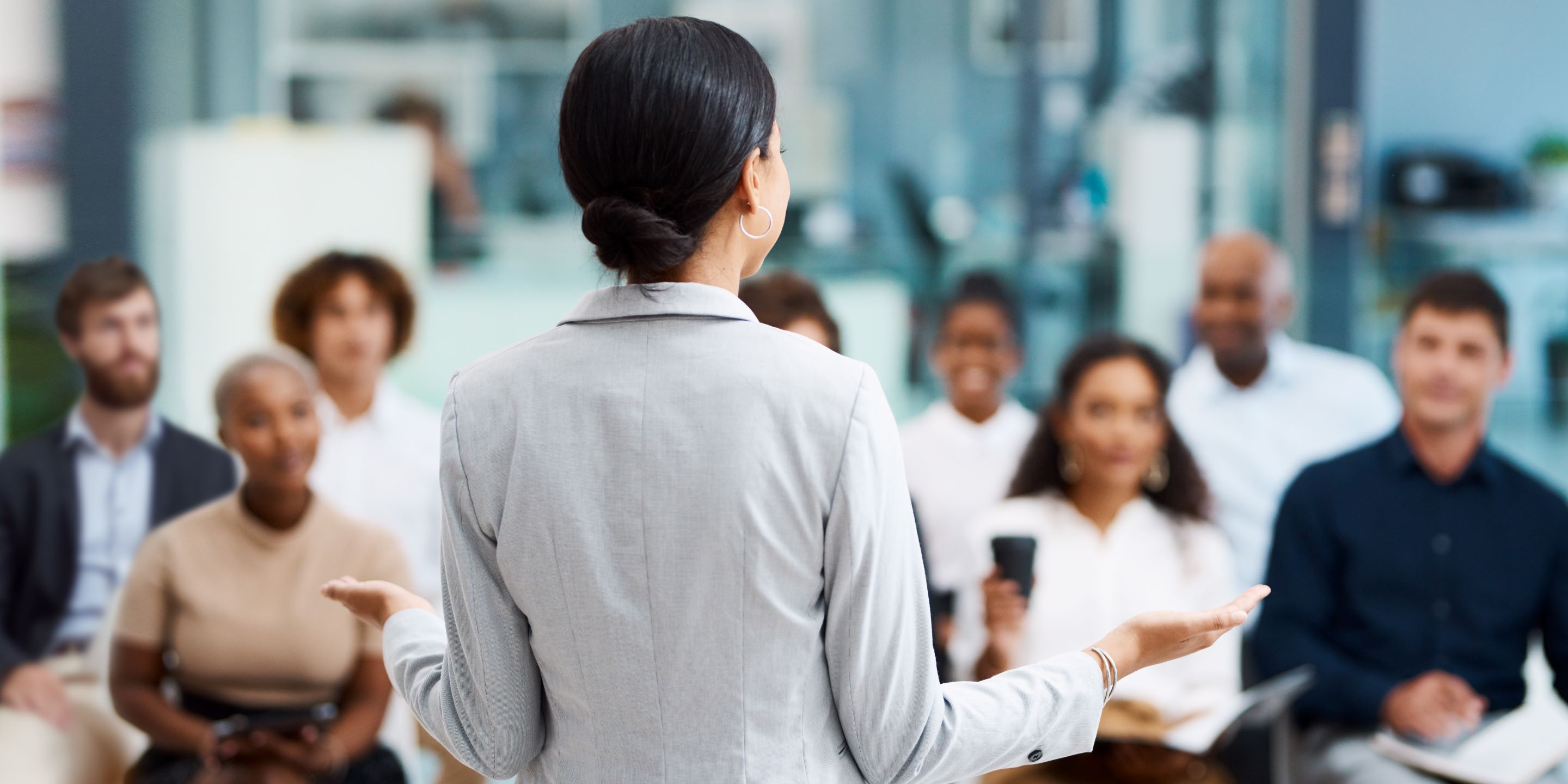 Female business woman presenting to group