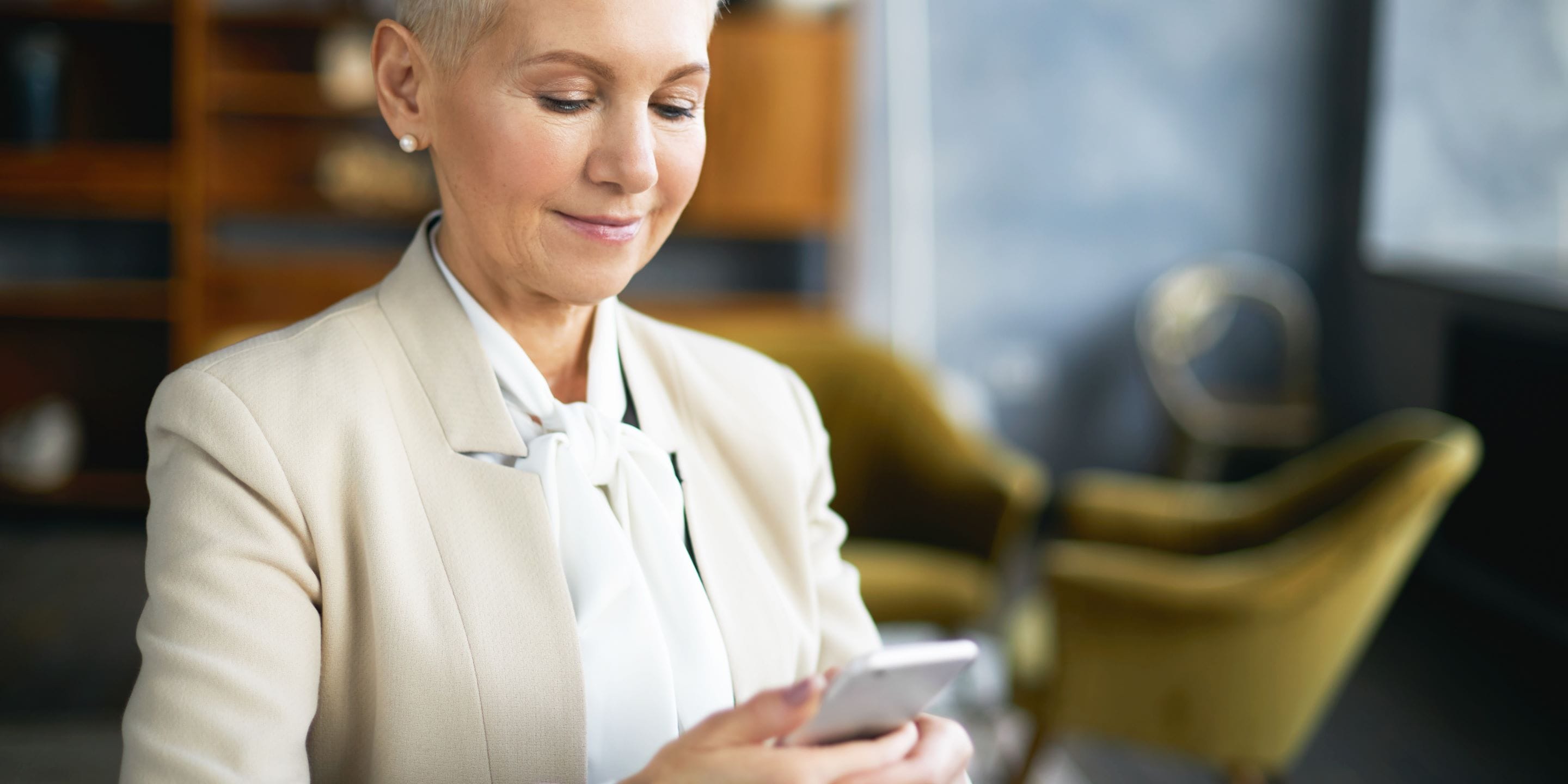 Supra female real estate agent holding mobile phone