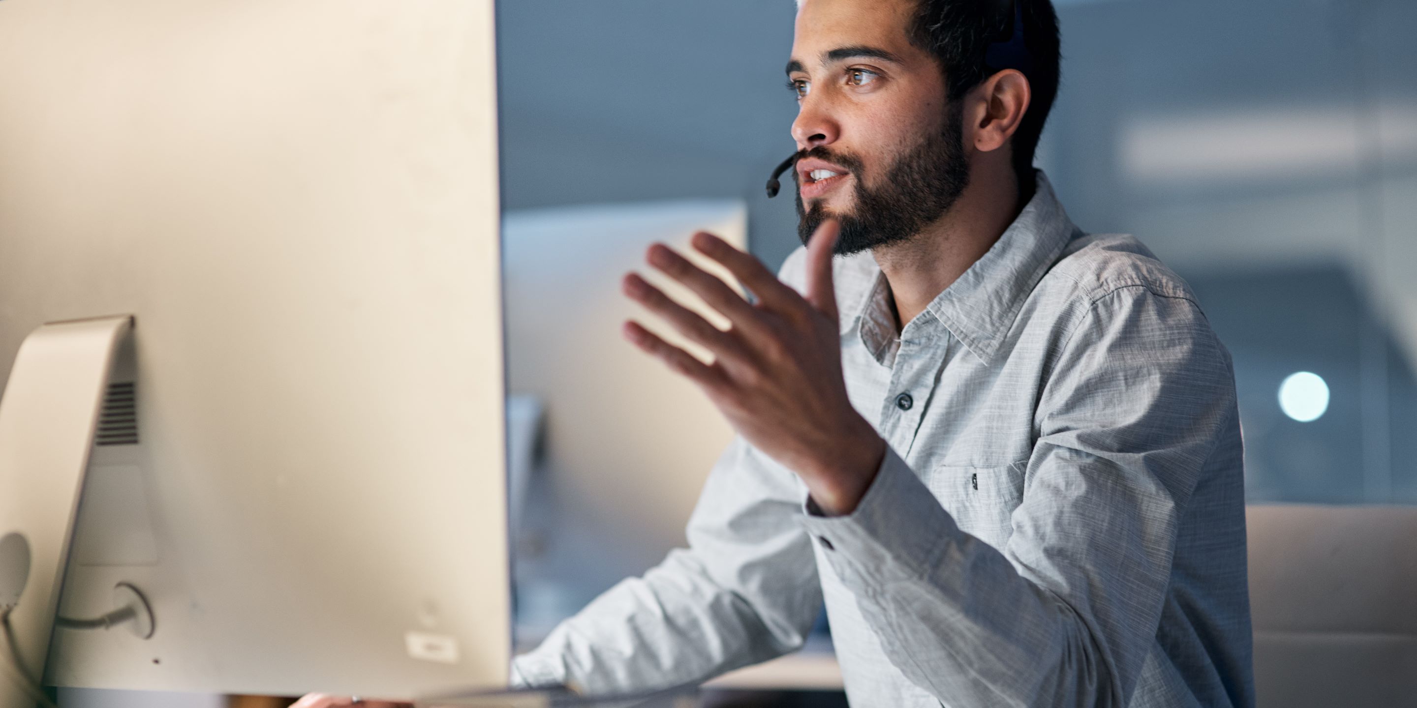 Young man with headset at a computer