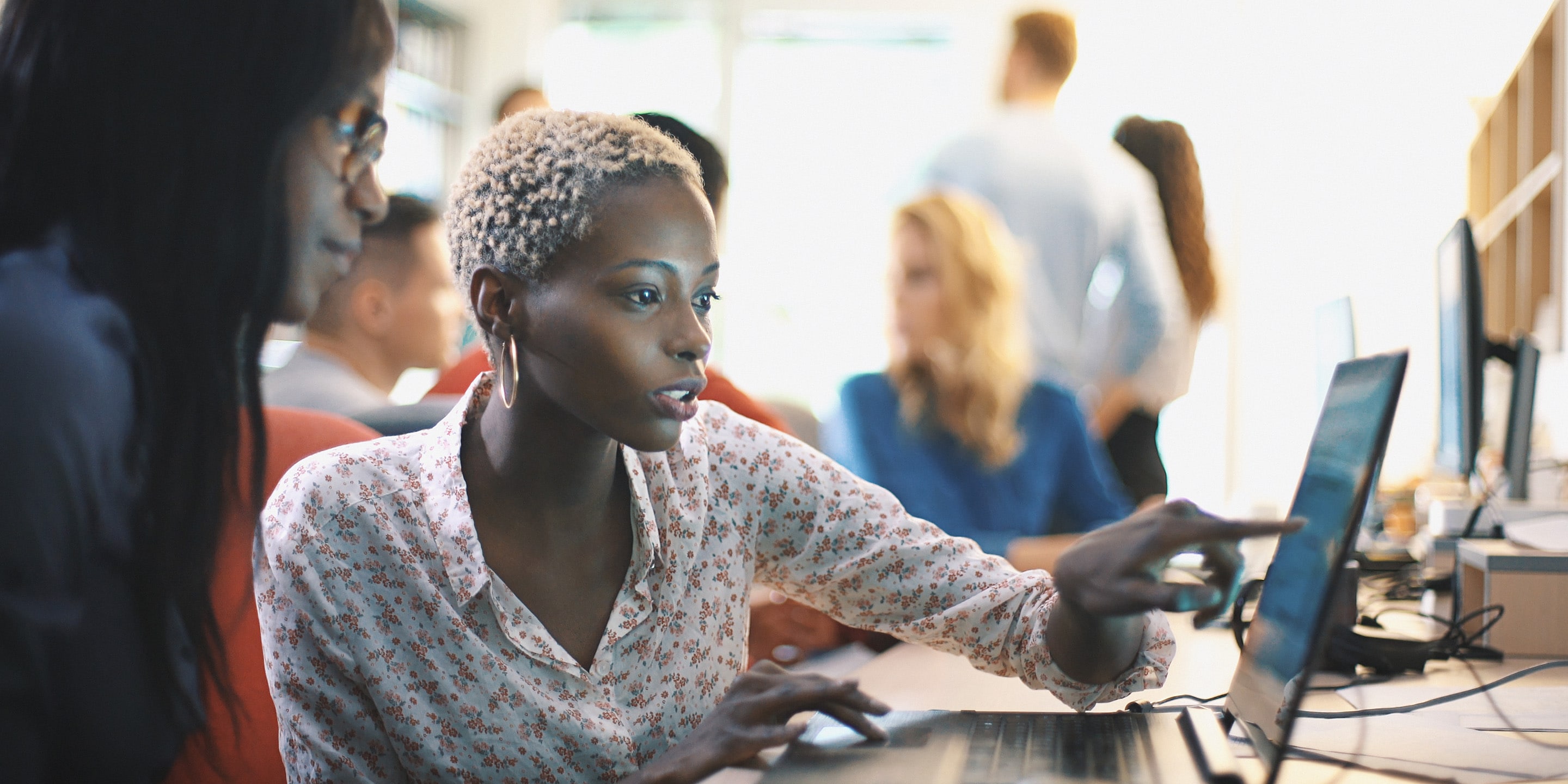 Woman at laptop with charger on desk