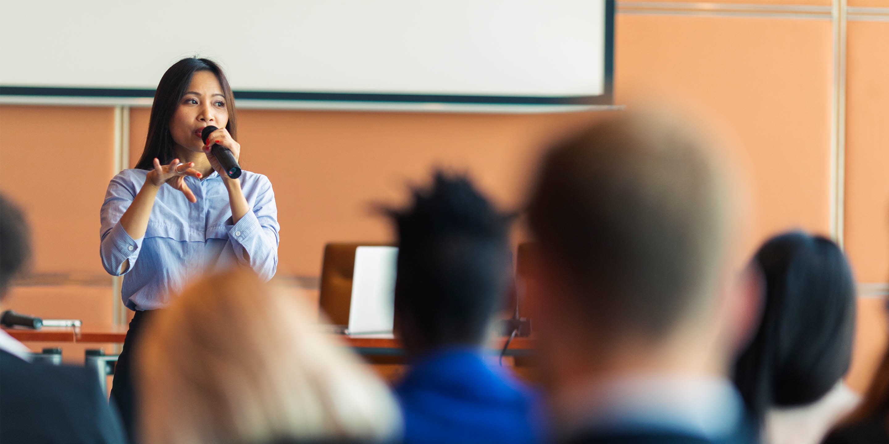 Woman speaking to a room of people 